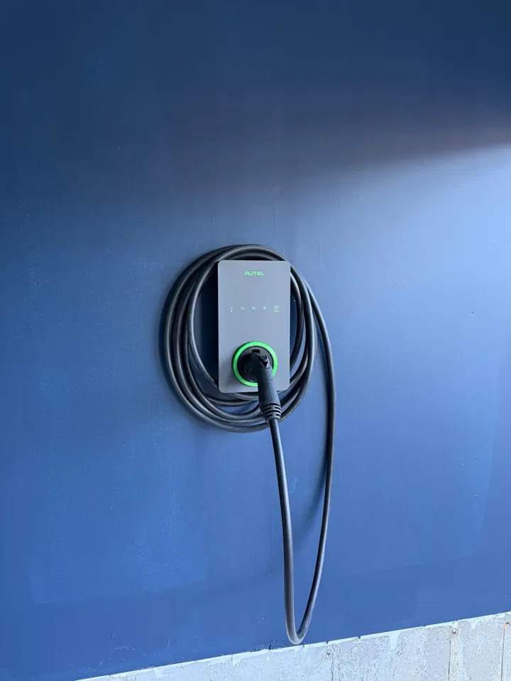 Autel EV charger on a blue garage wall