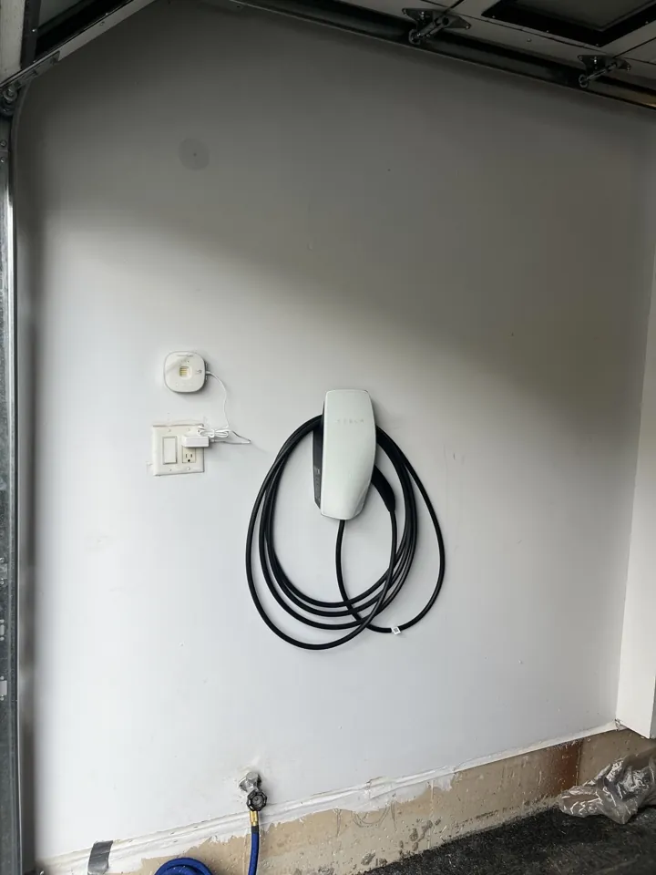 Tesla Wall Connector mounted inside a residential garage